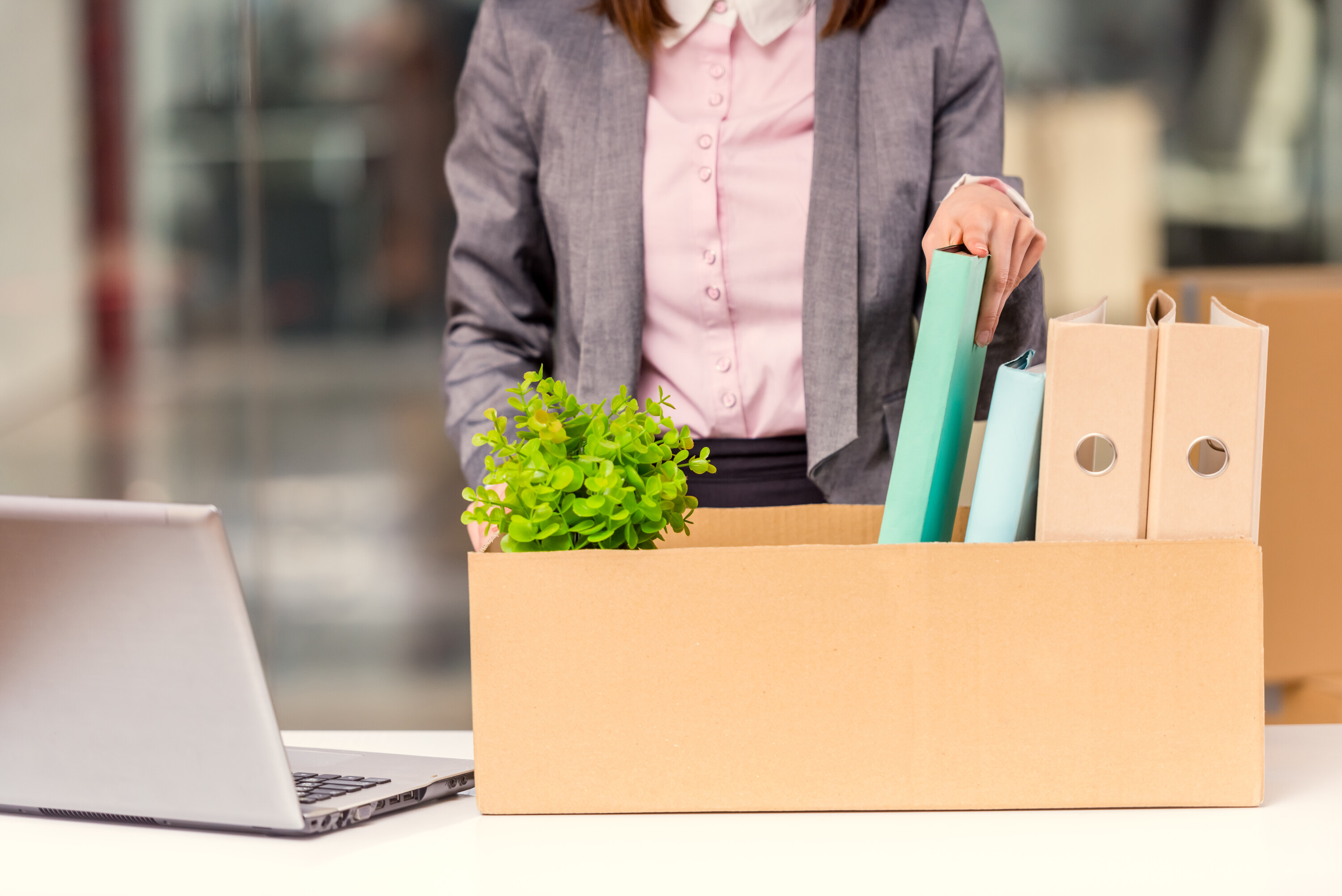 Office worker preparing a moving box for an office relocation