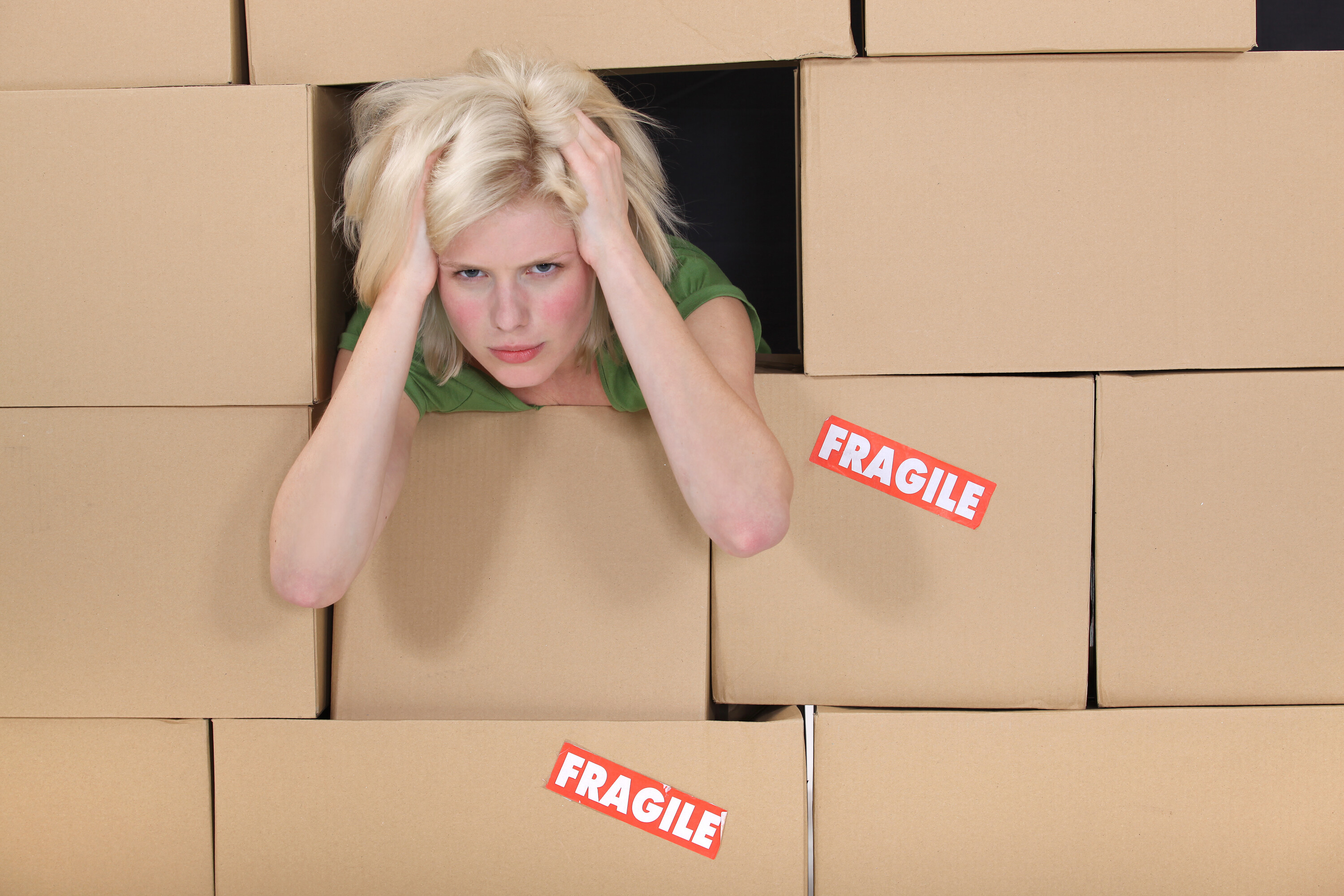 Stressed woman surrounded by boxes